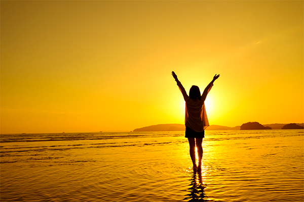 Silhouette of woman enjoying the sunset